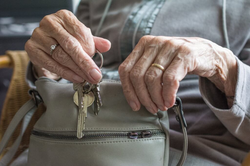 Elderly person with keys